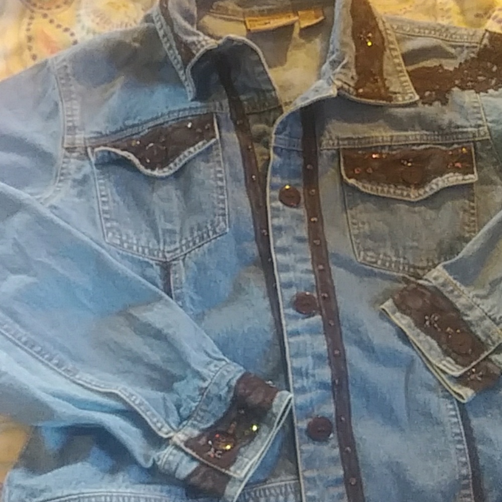 A jean jacket w/ lacey embroidery and bling